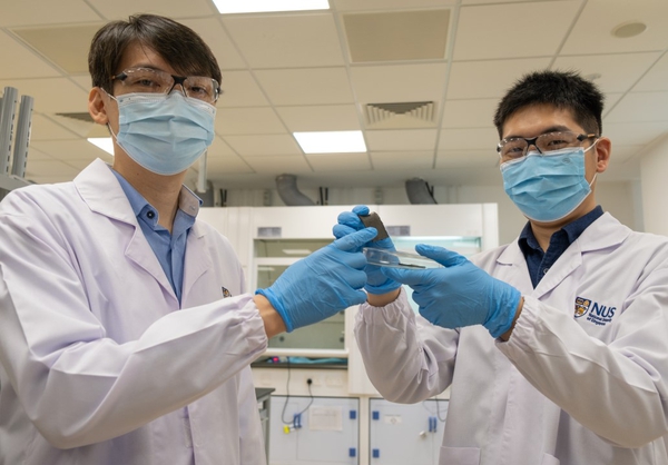 Assistant Professor Benjamin Tee (left) and doctoral student Guo Hongchen hold up a piece of AiFoam. Photo: National University of Singapore