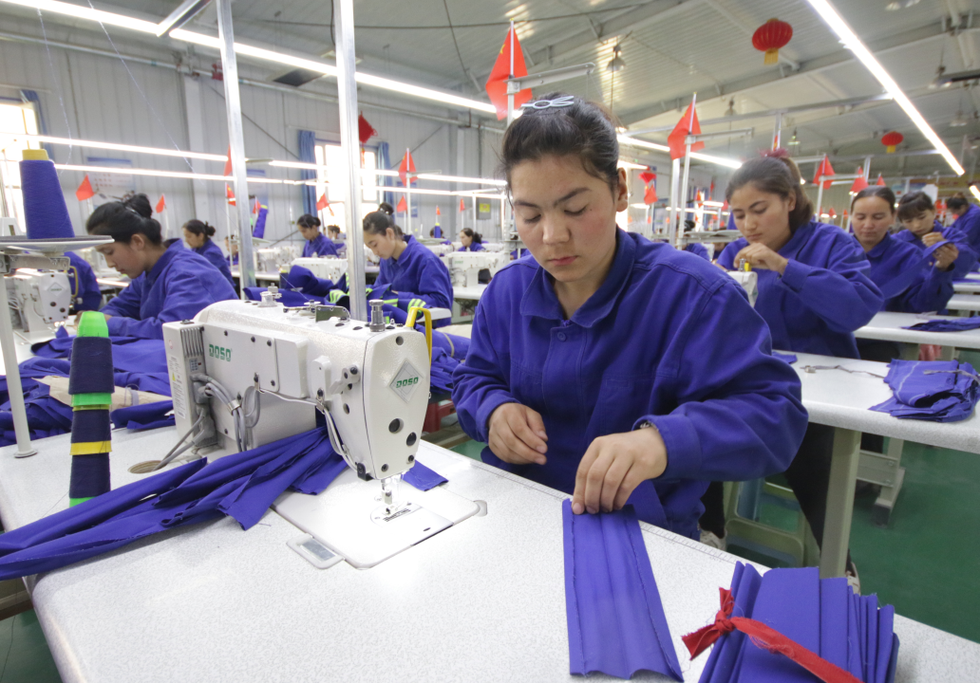Uyghur women working in a textiles factory. Credit: Azamat Imanaliev / Shutterstock