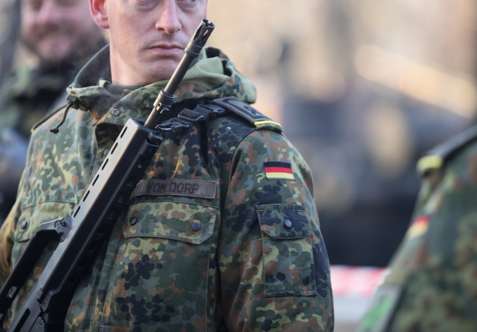 German soldiers, armed with Heckler &amp; Koch G36 5.56×45mm NATO assault rifle, taking part at the Romanian National Day military parade. Photo: M.Moira / Shutterstock