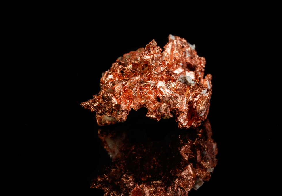 Copper ore on black background. Credit: Minakryn Ruslan / Shutterstock